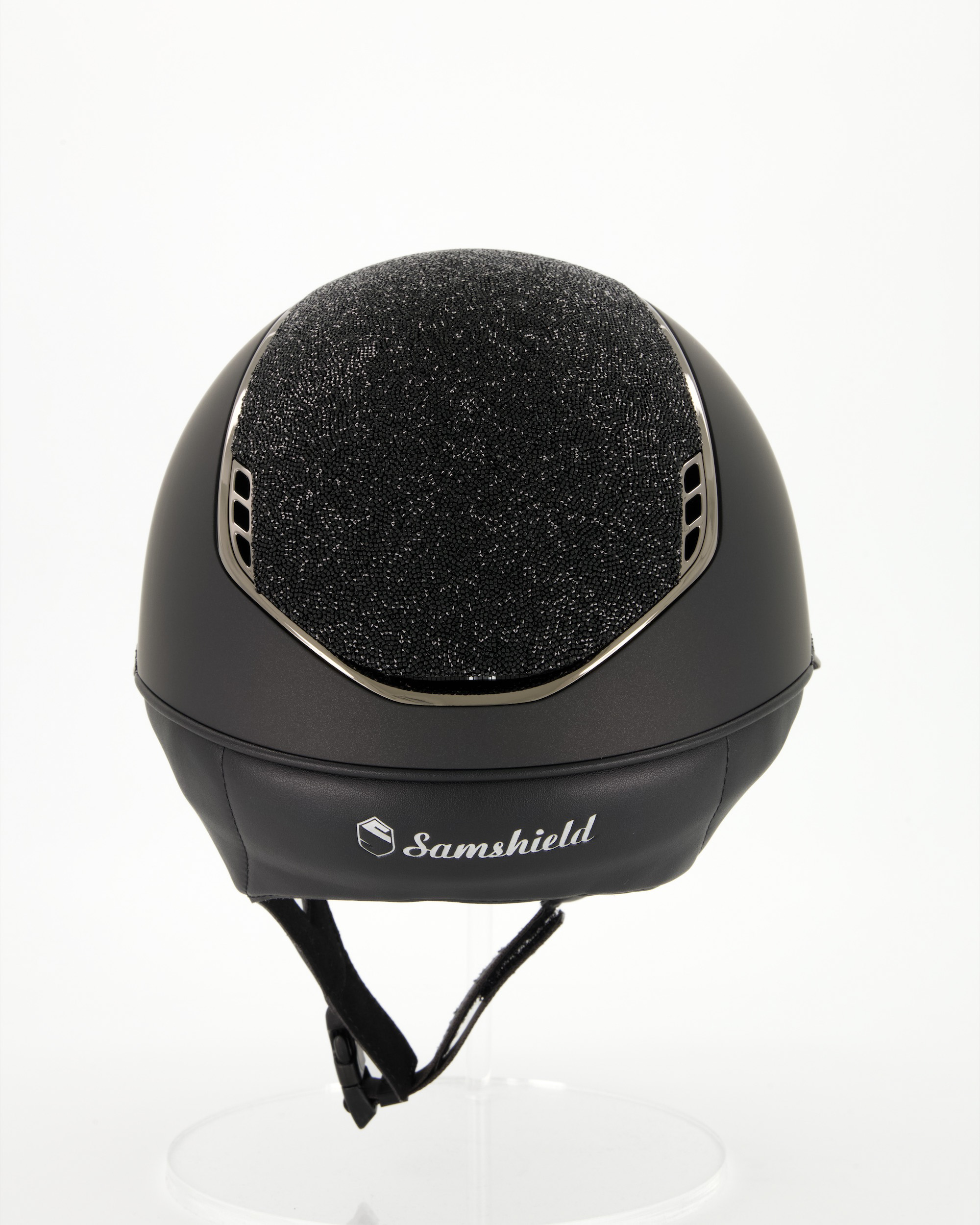 Riding helmet 2.0 Miss Shield Shadowmatt Black, Top and front strap Ultra Fine Rock, Trim and Blason Chrome Black in black
