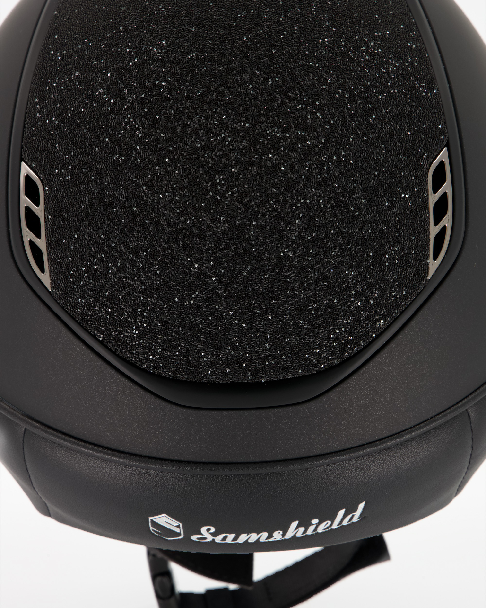 Riding helmet 2.0 Miss Shield Shadowmatt, Top Crystal Fabric Swarovski Black, Frontal Band Crystal Fabric Swarovski Black, Trim Matt Black, Blason Chrome Black in black
