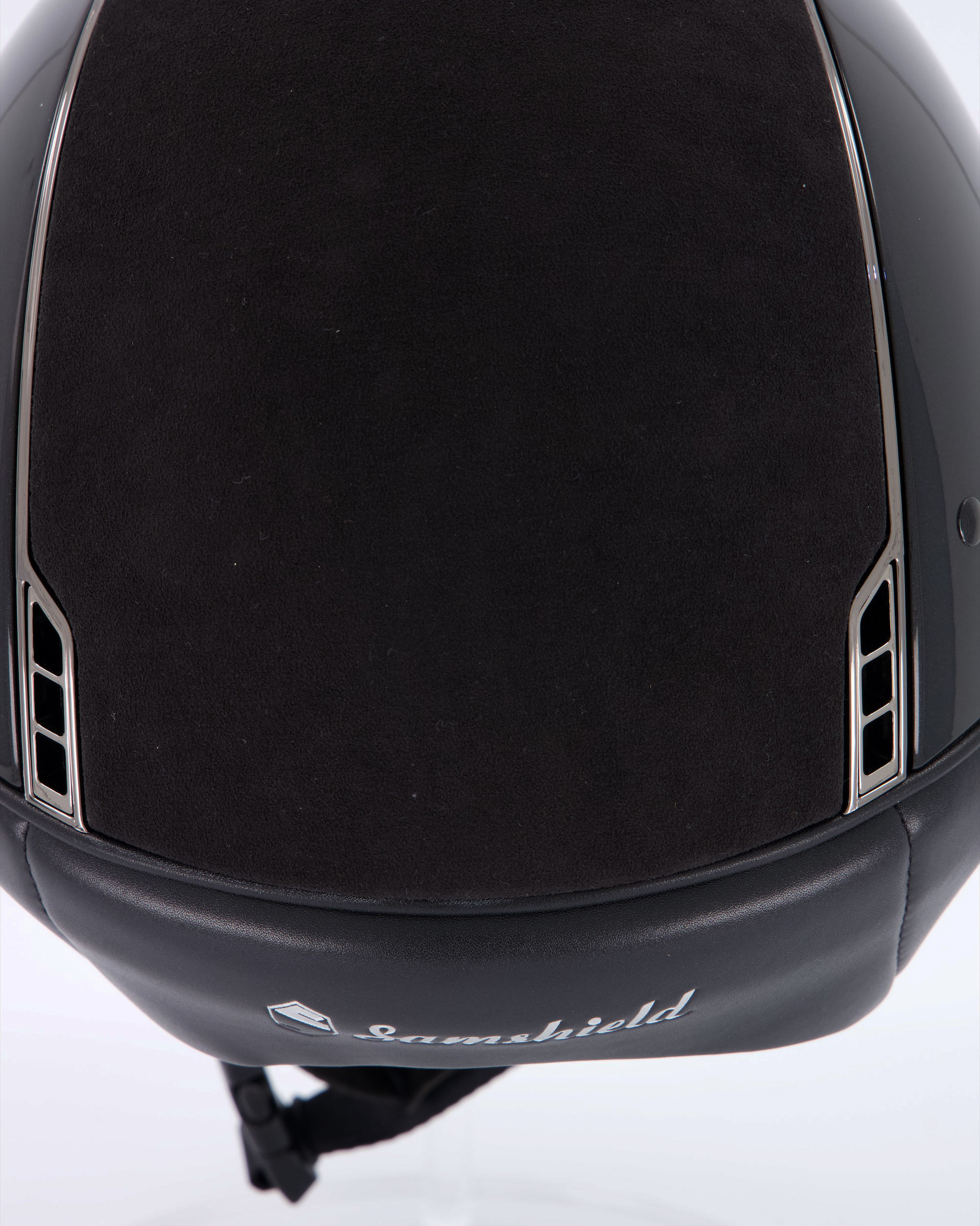 Riding helmet Miss Shield Shadowglossy Black, Top and frontal band Alcantara Black, Trim Matt Black, Blason Chrome Black, 5 Swarovski stones Black