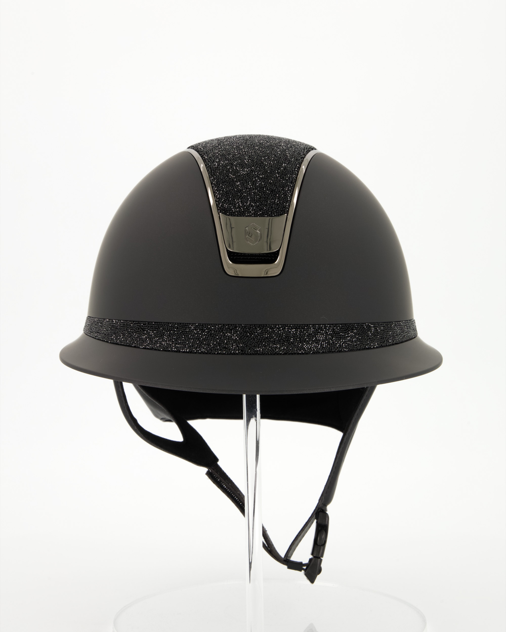 Riding helmet 2.0 Miss Shield Shadowmatt Black, Top and front strap Ultra Fine Rock, Trim and Blason Chrome Black in black