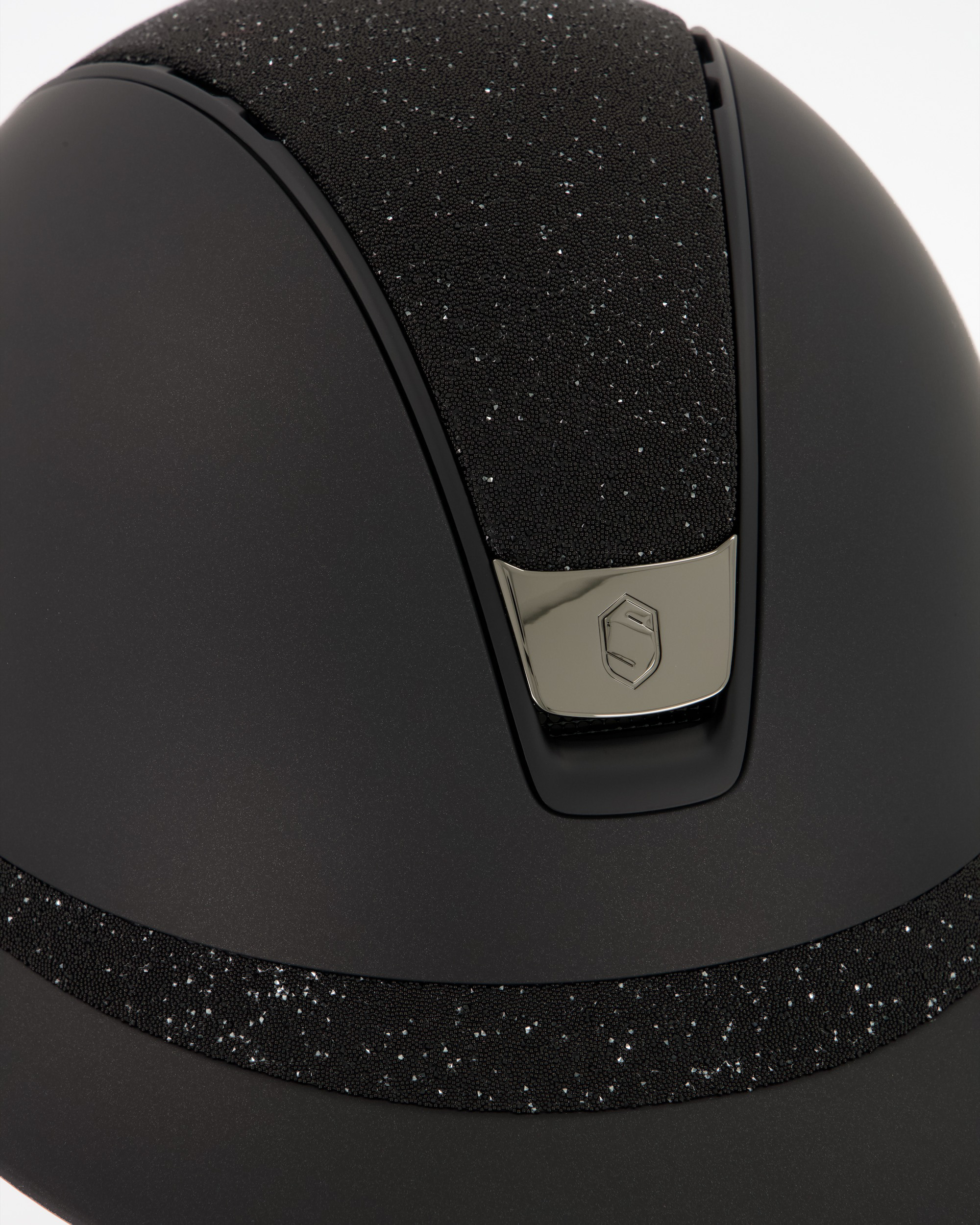 Riding helmet 2.0 Miss Shield Shadowmatt, Top Crystal Fabric Swarovski Black, Frontal Band Crystal Fabric Swarovski Black, Trim Matt Black, Blason Chrome Black in black